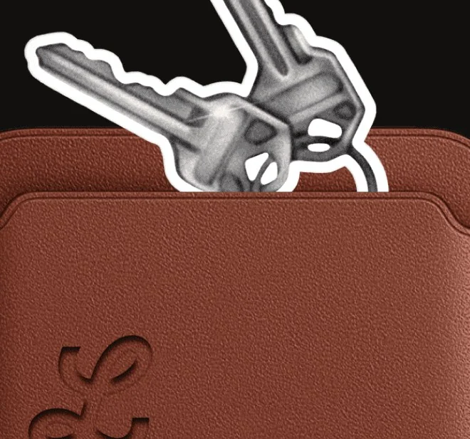 A brown leather wallet with a set of keys sticking out of it